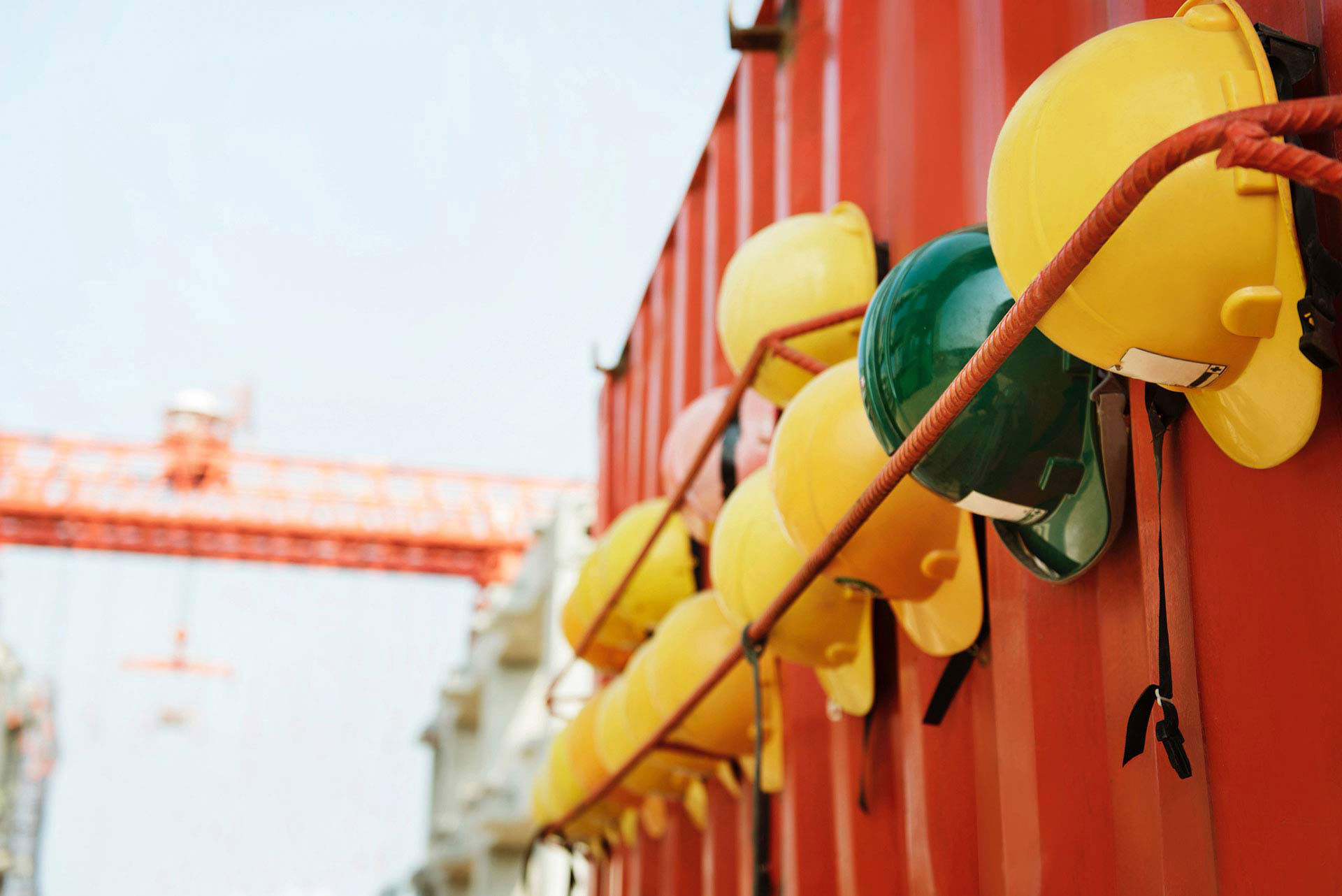 construction safety helmets on the orange wall